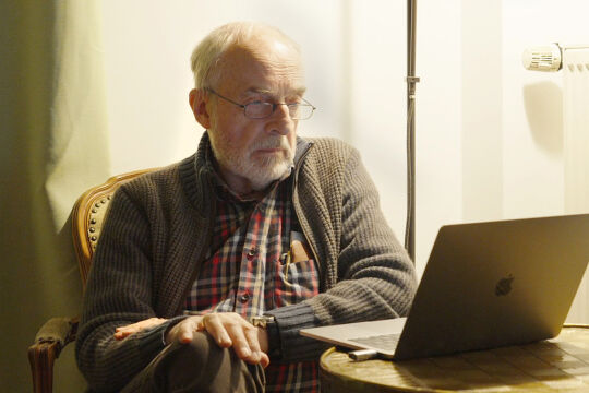 Johann F. Spittler - Das Porträt zeigt Doktor Friedrich Spittler vor seinem Laptop an einem Fenster.  - © "Grünes Licht" / Pavel Cuzuioc / Stadtkino Filmverleih