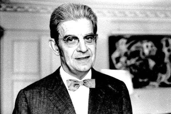 Jacques Lacan - Schwarz-weiße Aufnahme von Jacques Lacan in Anzug mit Fliege vor einer Wand mit abstraktem Gemälde. - © Foto: IMAGO / Photo News